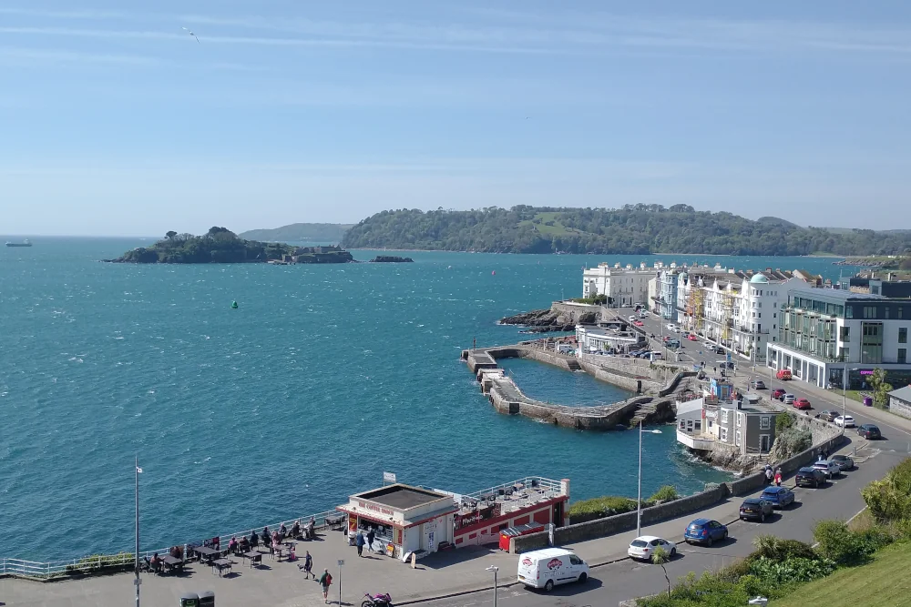 Plymouth Sound on a blustery day, with waves rolling across the harbour and wind sweeping through the coastline.